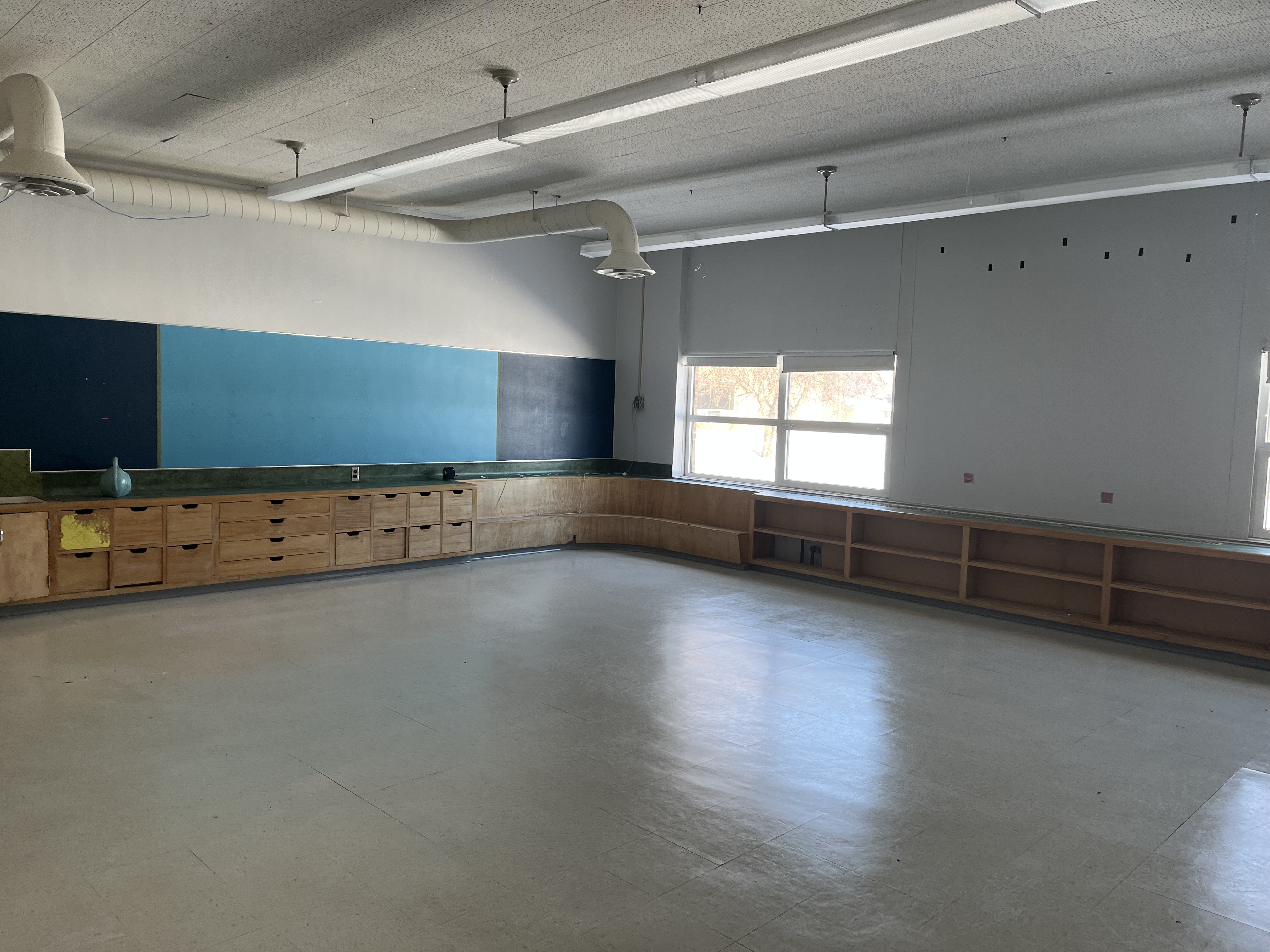 Vocational classroom with blue chalkboard and cabinets