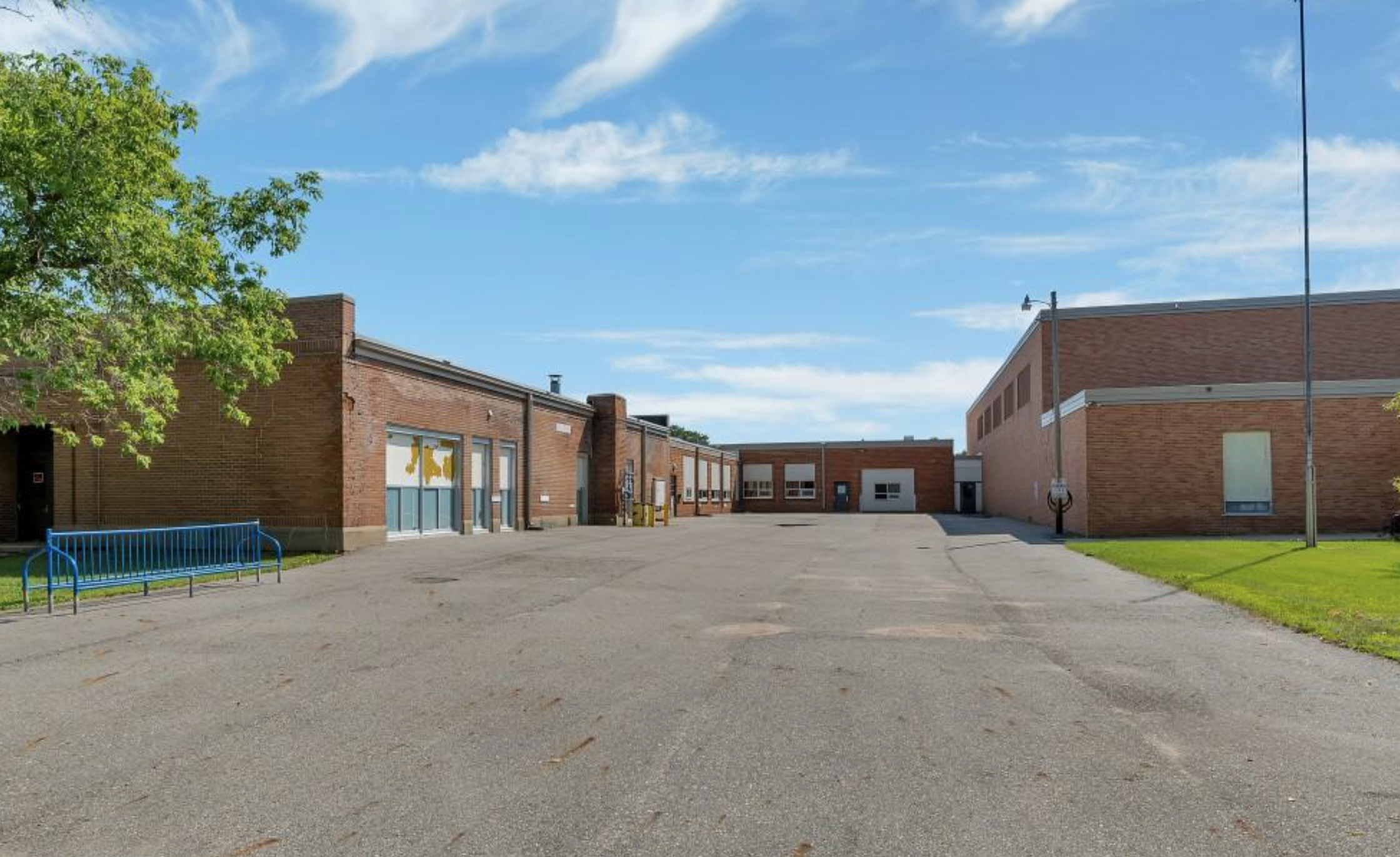 Property exterior rear view with parking lot and loading dock