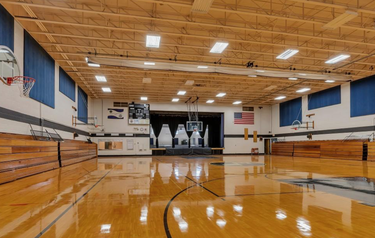 Gymnasium with stage and American flag