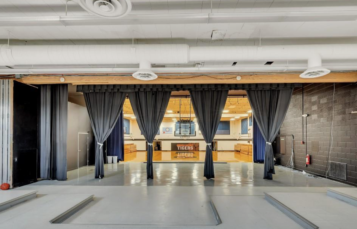 Stage curtains with view into gymnasium